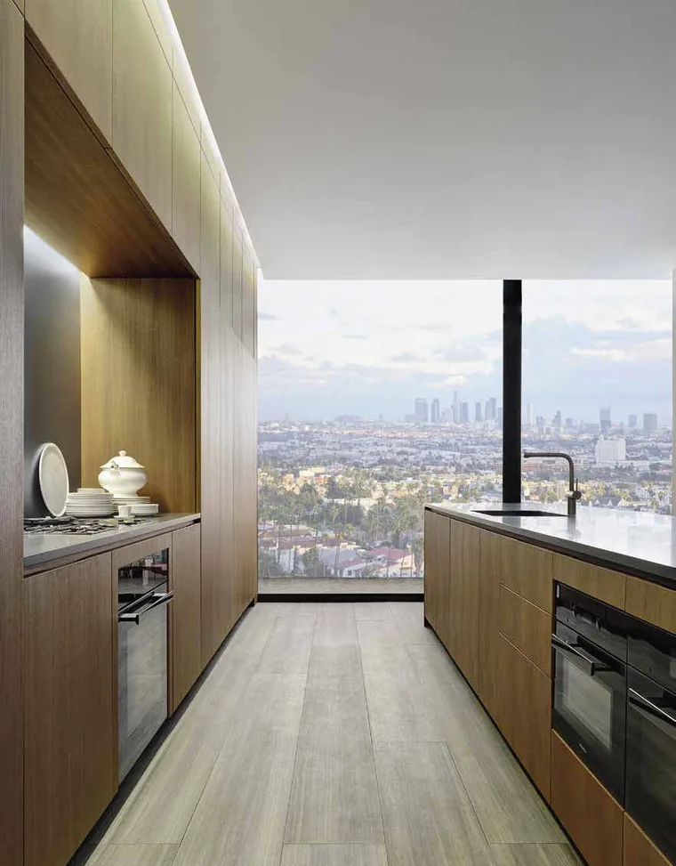 Italian minimal kitchen with full-height handleless veneer fronts
