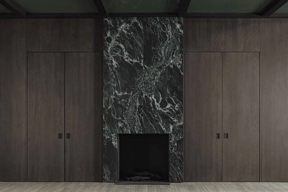 Master suite with full-height walnut fronts and a stone back panel, handleless