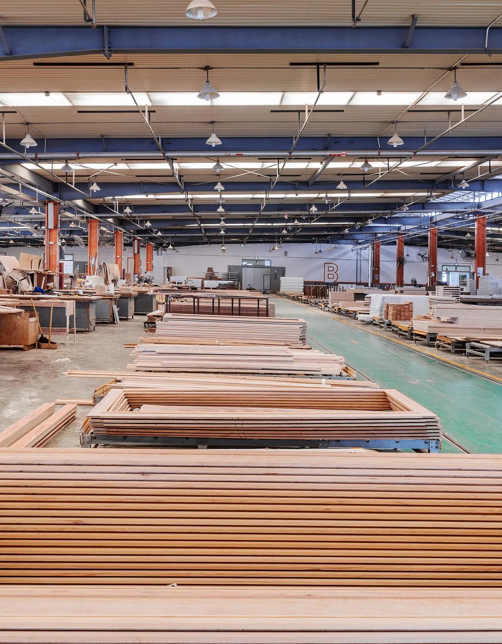 Door frames and boards waiting for machining inside the Qisheng factory